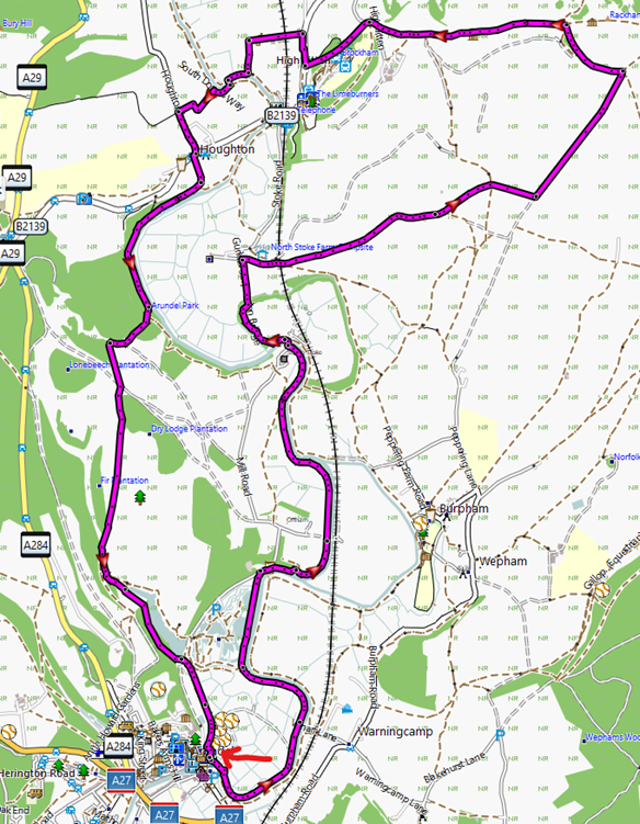 Map with a winding purple route looping around a rural area, passing through towns and green fields.